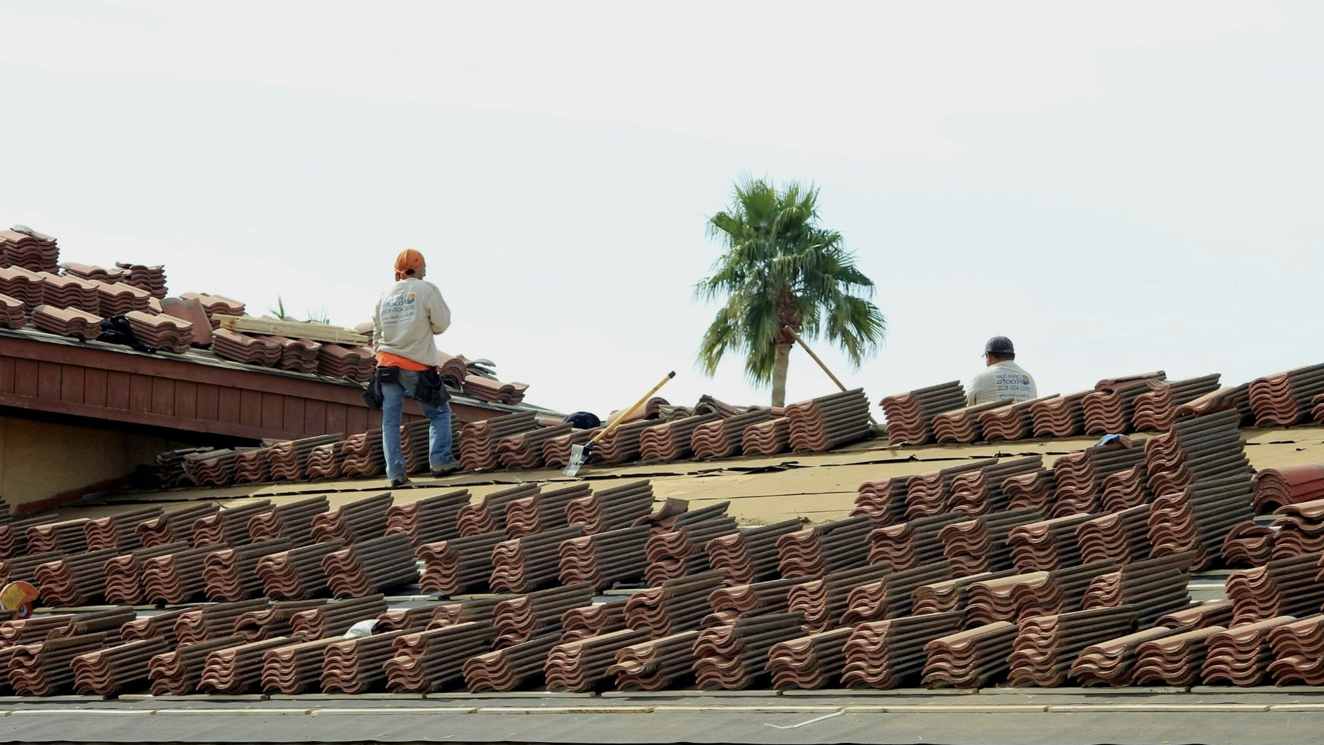 Men installing a new roof on a house